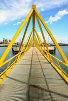 a yellow bridge with a blue sky in the background photo
