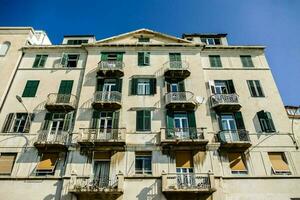 un antiguo edificio con verde persianas y balcones foto