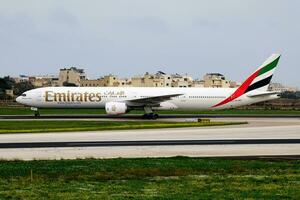 Emirates passenger plane at airport. Schedule flight travel. Aviation and aircraft. Air transport. Global international transportation. Fly and flying. Arrival and landing. photo