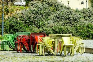 colorful chairs and tables in a park photo