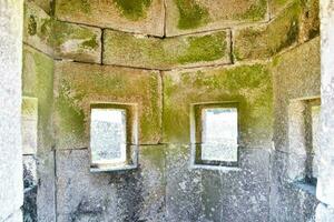 the inside of a stone building with windows photo