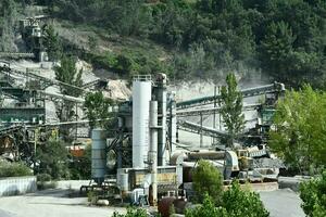 a large cement plant with conveyor belts and trucks photo