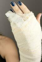 Young Lady with a bandage on her hand where she broke her little finger photo