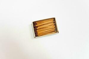 Row of red match sticks isolated on white background. Burnt matches and whole matches on white background. photo