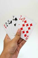 Playing cards in hand isolated on white background photo
