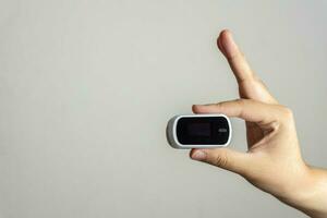 Close up of human finger while using Pulse Oximetry isolated on white background. photo