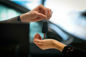 Buy a car conceptual background. Give a new car keys in a car salon photo