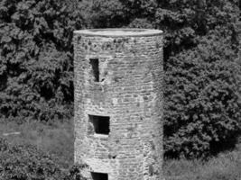 Old celtic castle tower among the trees, Blarney castle in Ireland, old ancient celtic fortress photo