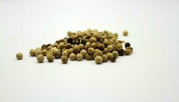 Pepper seeds isolated on white background. Culinary aromatic spices. photo