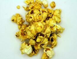 Popcorn isolated on white background, closeup of a pile of popcorn photo