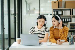 Two young Asian female college students working on the school photo