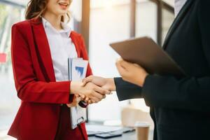 Two confident business man shaking hands during a meeting in the office, success, dealing, greeting and partner photo