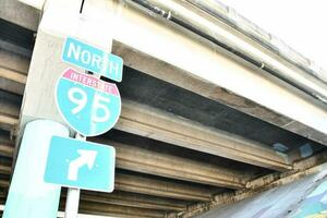 a street sign for north 95th street is seen under an overpass photo