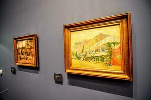 two paintings on display in a museum photo