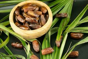 Fruits of the date palm Phoenix dactylifera and bacon photo