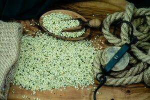 peeled hemp seeds on olive wood photo