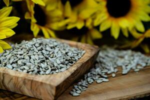 Sunflower Helianthus annuus Seeds on olive wood photo