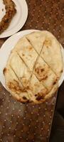 Butter naan roti served in a plate. Fast food item. Delicious homemade Naan. photo