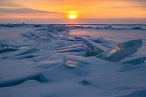 Beautiful landscape of Uzury bay with ice hummock rising above the frozen lake of Baikal at sunrise. Uzury is a very little settlement located on the eastern side of Olkhon island. photo