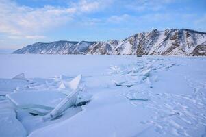 Beautiful landscape of Uzury bay with ice hummock rising above the frozen lake of Baikal. Uzury is a very little settlement located on the eastern side of Olkhon island. photo