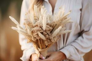 Woman holding a bunch of dried pampas grass. Generative AI photo