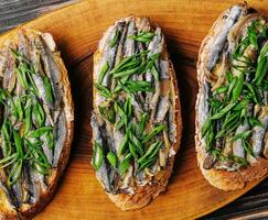 Top view pickled anchovies with spring onions photo