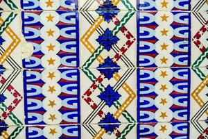 colorful tile pattern on the wall of a building photo