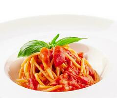 Spaghetti with tomato sauce and cherry tomatoes with basil photo