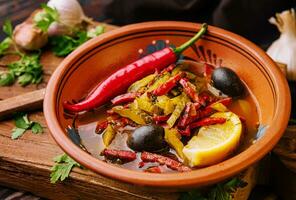 Meat Solyanka soup on a wooden board photo