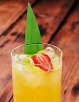 mai tai cocktail with pineapple and rum with a piece of strawberry photo