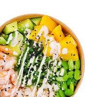 bowl with shrimp, pineapple, avocado, beans and seaweed photo