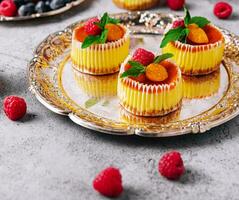 Mini cheesecake with apricot in muffin forms photo