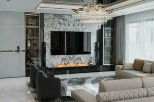 A TV hanging on the marble Wall mounted under the firebox in the modern minimal living room. photo