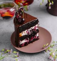 Chocolate cake with cherries and chocolate cream photo