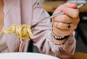 Woman Eating pasta with Mushrooms close up photo