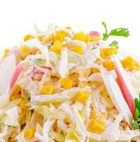 Salad with corn, crab sticks, cucumbers, eggs and mayonnaise photo