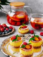 Mini cheesecake with apricot in muffin forms photo