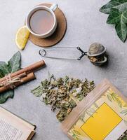 cup of tea with lemon slices and tea packaging photo