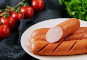 boiled sausages with cheese on plate photo