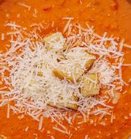 Pumpkin carrot cream soup with parmesan photo