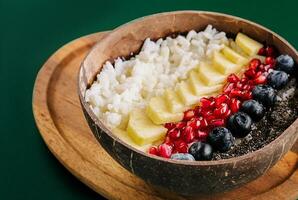 bowl of rice, pineapple, pomegranate and blueberries photo