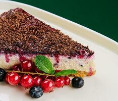vanilla cheesecake with chocolate sauce and berries photo