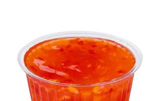 red sweet and sour sauce isolated on white photo