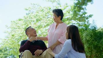 A daughter taking care of the patient in a wheelchair and talk with mom. Concept of happy retirement with care from a caregiver and Savings and senior health insurance, Happy family and retirement photo