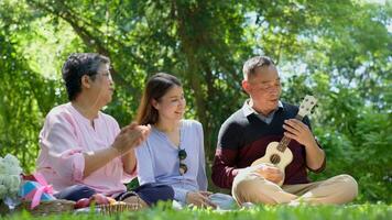 Happy old elderly couple spouses relaxing and sitting on a blanket in the park and sharing few precious memories. Senior couple having great time together on a picnic. concept of mature relationships photo