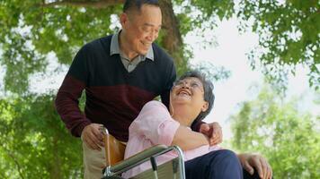 Elderly couples or caregivers take care of the patient in a wheelchair.  Concept of a happy retirement with care from a caregiver and Savings and senior health insurance, a Happy Family photo