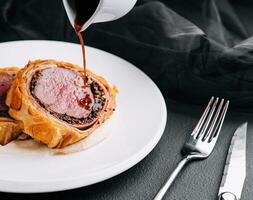 Fillet wellington in puff pastry on plate photo