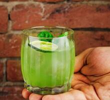 Fresh summer green basil cocktail in a glass photo