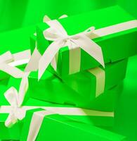 Green gifts on a green background photo