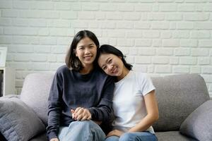 Two young Asia women showing love and romance together at home. LGBTQ Lifestyle Concept photo